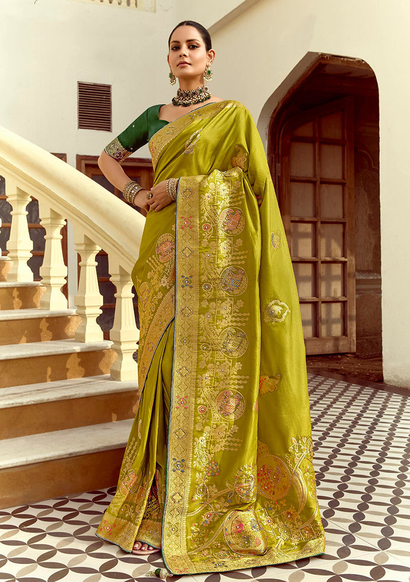 Olive green silk blend saree with gold weaving and swarovski crystal details for traditional celebrations.