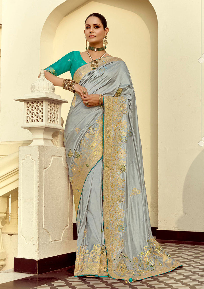 Light grey silk blend saree with intricate weaving and Swarovski crystals.