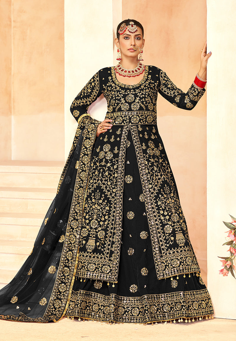 Model wearing a black embroidered velvet lehenga choli with intricate detail