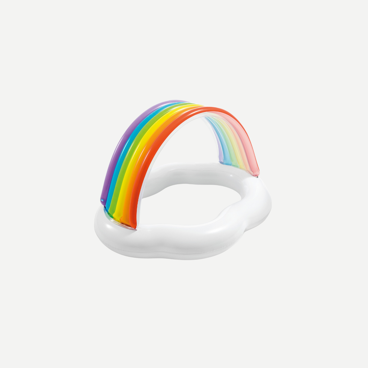 A toddler playing in a white inflatable baby pool with a vibrant rainbow arch canopy on a grassy lawn.