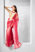 A beautiful red and gold tissue net saree displayed for party wear