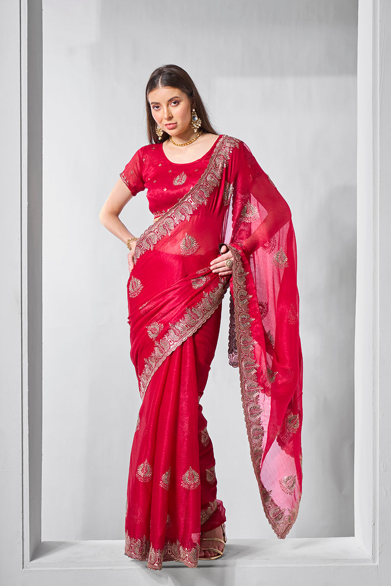 Rani pink chiffon saree with intricate gold embroidery and traditional drape