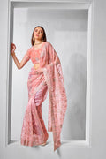 Peach colored tissue net saree featuring delicate gold embroidery.