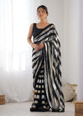 Elegant black georgette saree featuring detailed sequin work for festive parties.