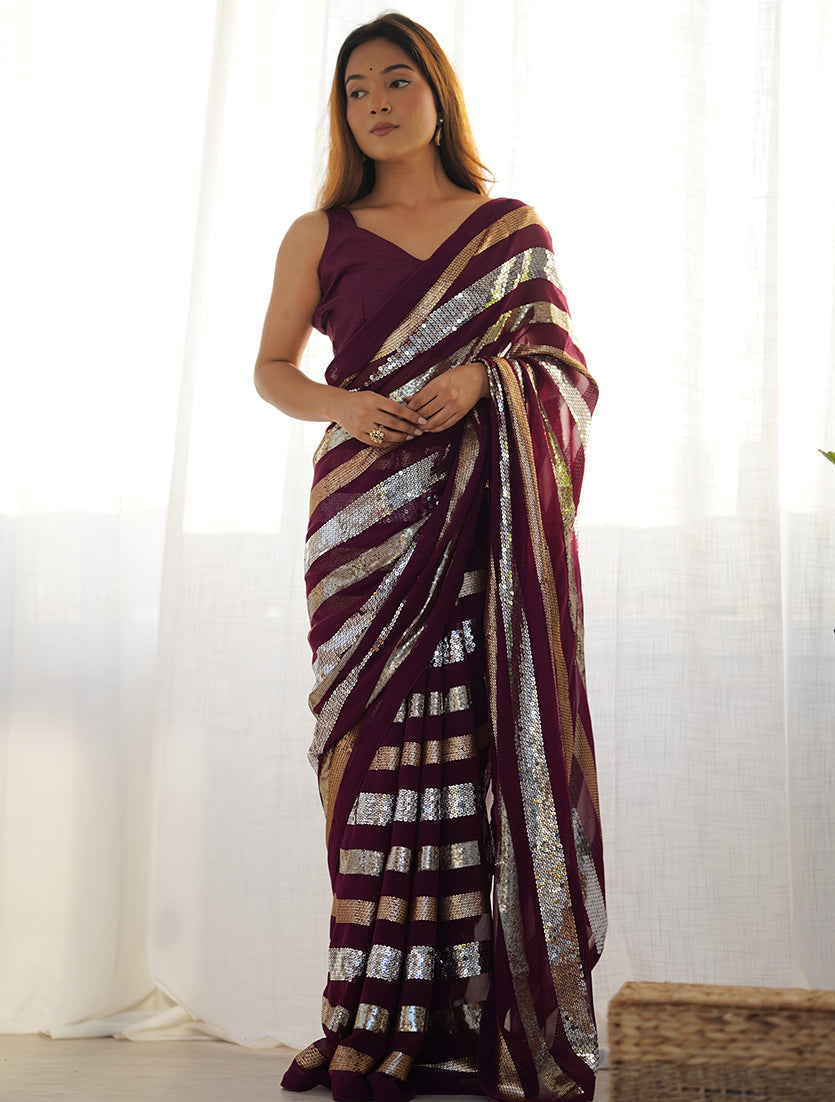 Beautiful wine-colored georgette saree adorned with sequin work along the border.