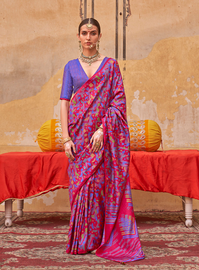 A stylish rani pink silk blend saree featuring intricate ethnic prints.