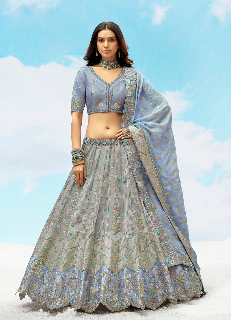 A luxurious grey and light blue heavy embroidered silk lehenga choli for weddings.