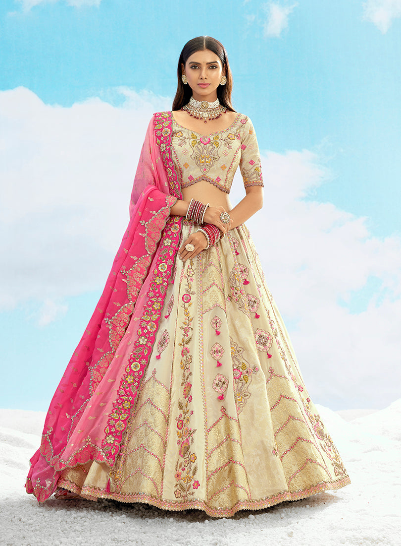 Cream and pink silk lehenga choli with heavy stone and embroidery work