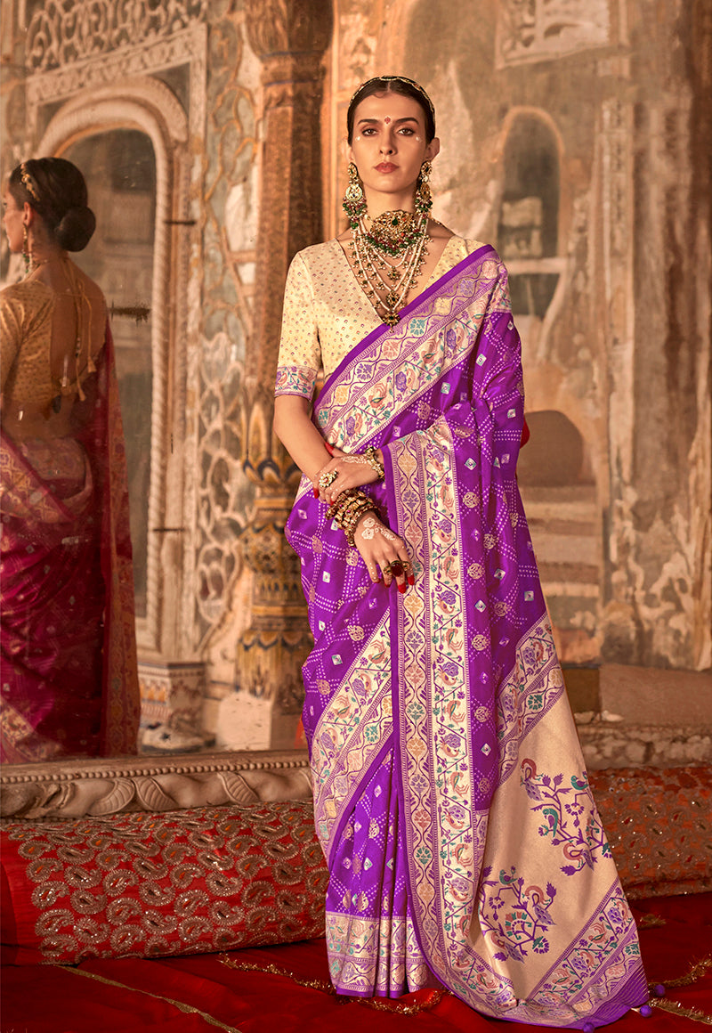 Woman wearing a dark violet Bandhej print silk blend saree with traditional cream accents