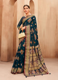 Teal georgette saree featuring detailed woven work, perfect for festivals.