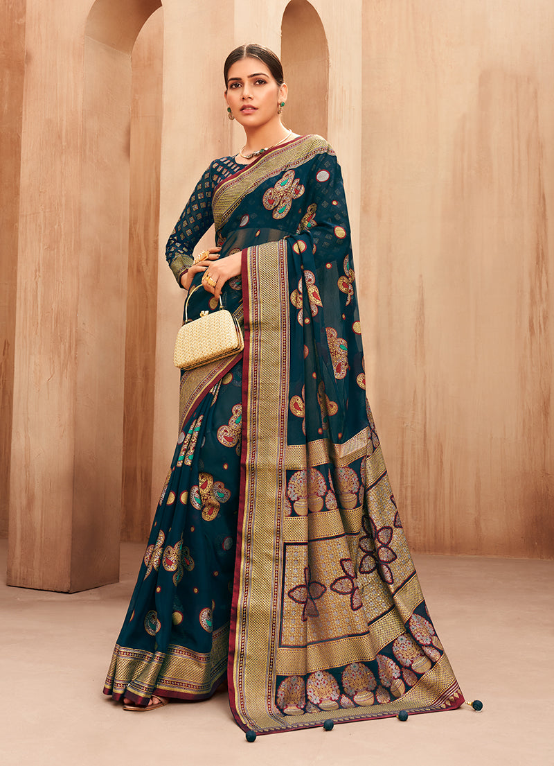 Teal georgette saree featuring detailed woven work, perfect for festivals.