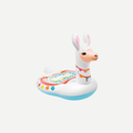 A person sitting on a white Mega Llama inflatable pool float in blue pool water.