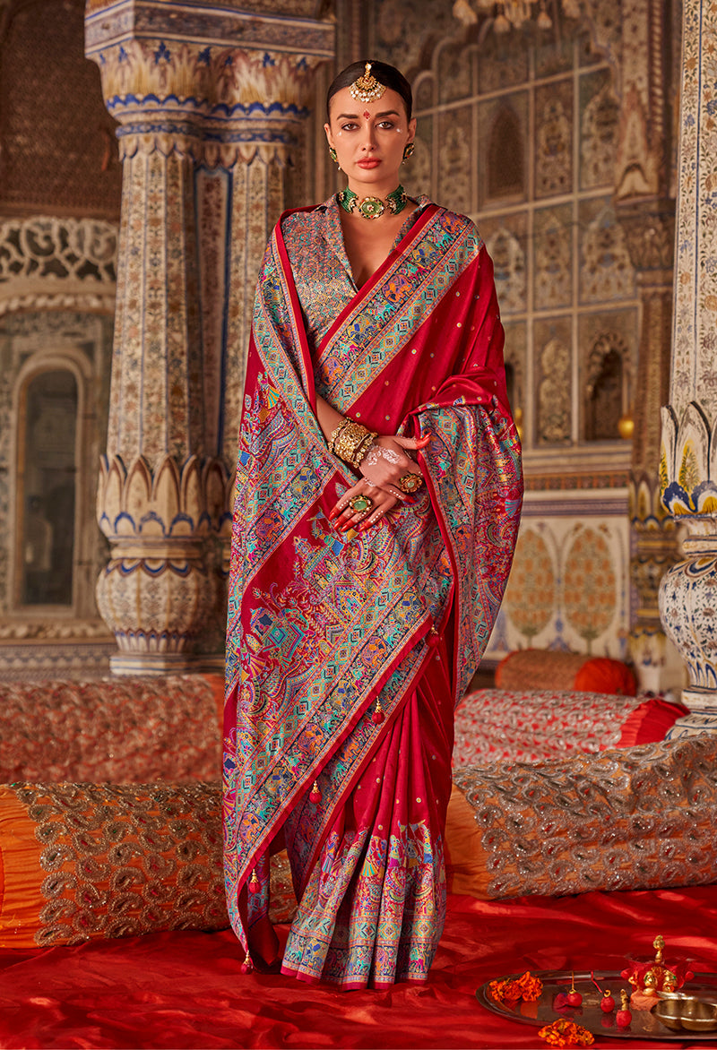 Vibrant crimson red silk blend saree with printed design and embellishments.