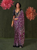Model wearing a purple satin crepe printed contemporary saree with matching blouse