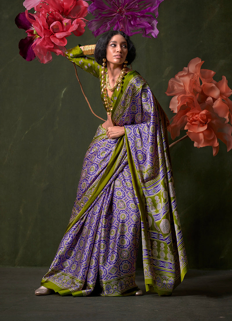 A modern violet satin crepe saree with geometric prints, draped to display the luxurious sheen and elegant fall.