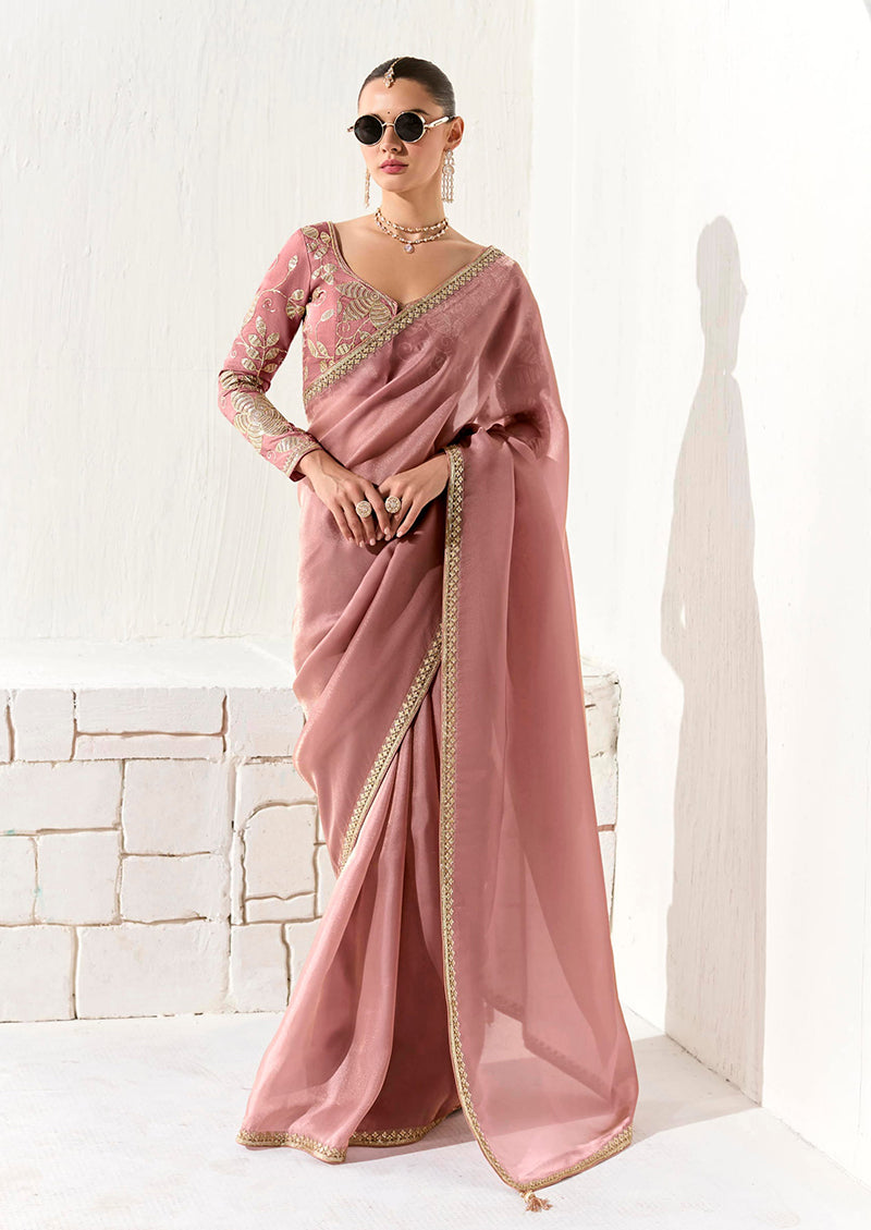 Dusty rose tissue organza saree featuring ethnic sequins and detailed embroidery.