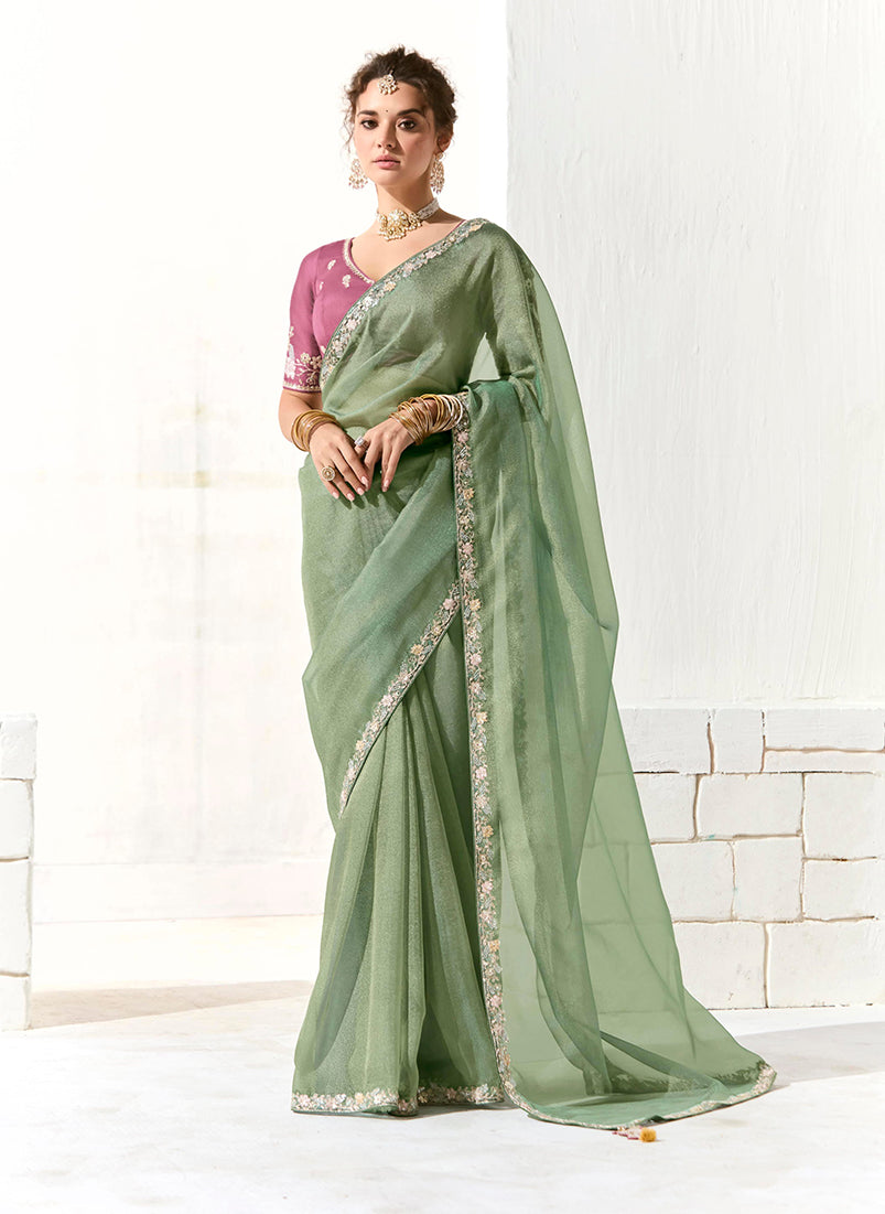 Dark sea green tissue and organza saree adorned with all-over sequin and embroidery work.