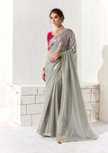 Light grey tissue organza saree with ethnic sequins and zari embroidery.