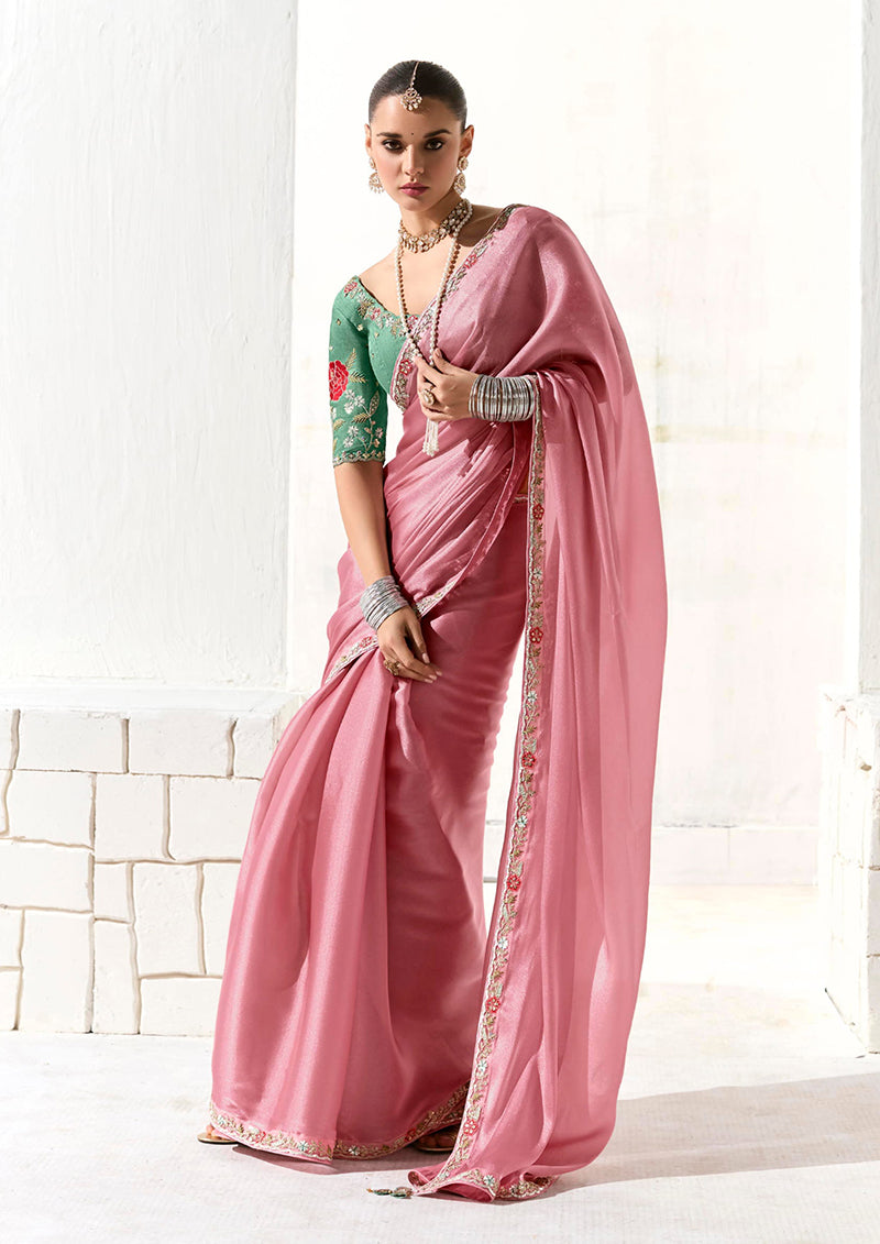 Pink tissue designer saree featuring an intricate embroidered border