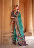 Turquoise silk blend saree with elegant print work.