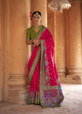 Vibrant rani pink classic saree in a silk blend fabric with intricate print work.