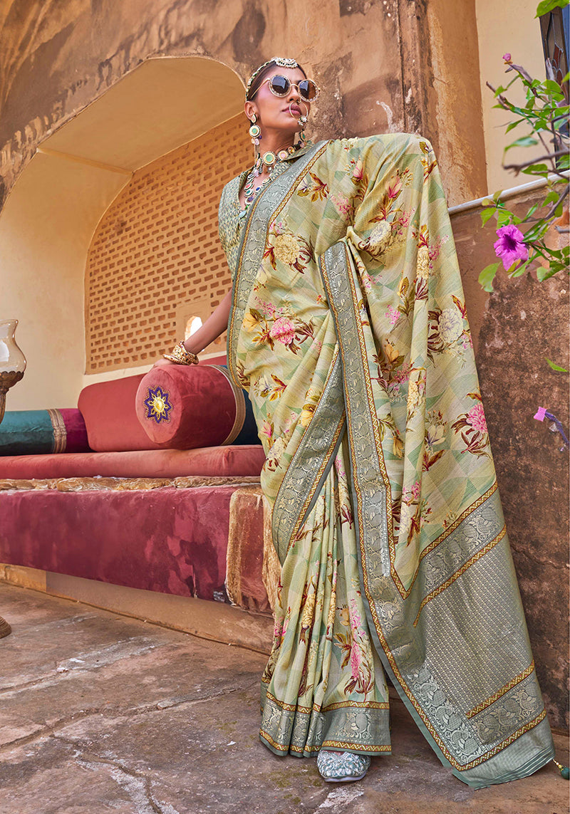 Light green silk blend saree with floral prints and a decorative tasseled pallu