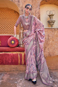Pink silk blend saree with floral print, woven border, and tasseled pallu.