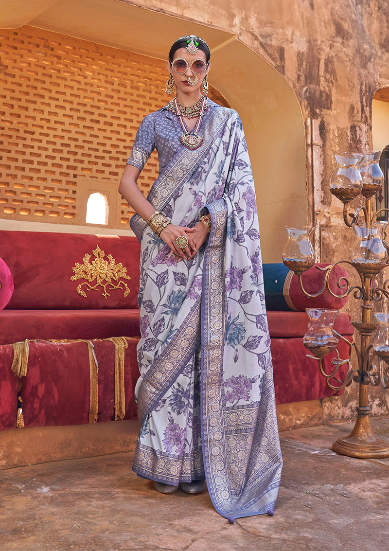 Light lavender silk blend saree featuring floral patterns and tasseled pallu