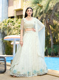White organza lehenga choli embellished with sequins and stone work