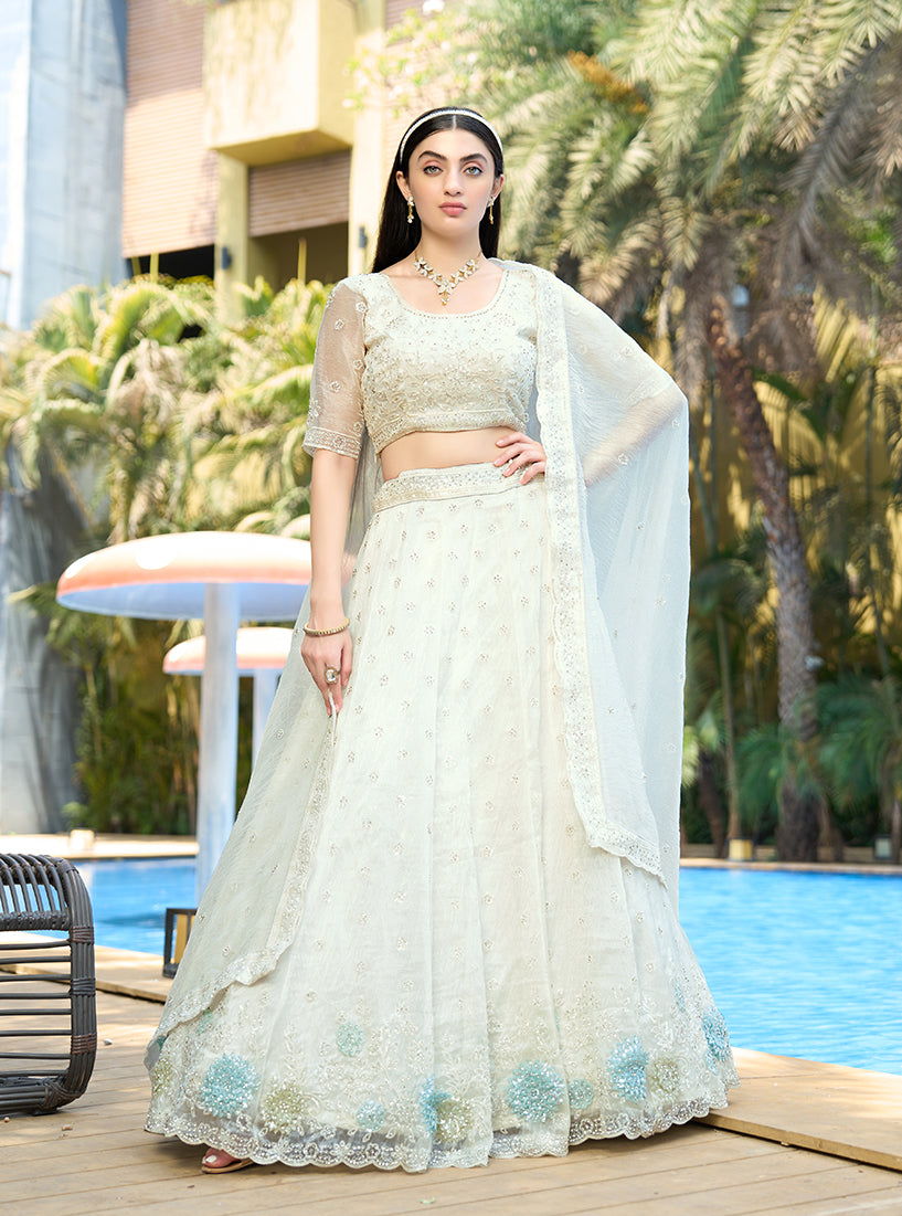 White organza lehenga choli embellished with sequins and stone work