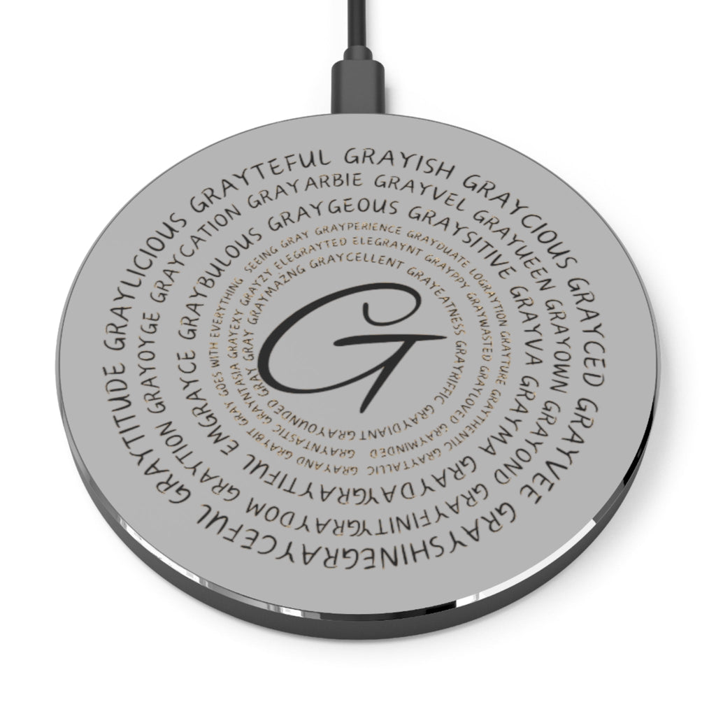 A sleek, minimalist wireless charger in black or silver finish on a modern desk.