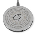A sleek, minimalist wireless charger in black or silver finish on a modern desk.