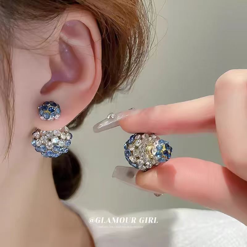 A pair of dual-wear diamond round stud earrings with silver needle posts for front-and-back styling.