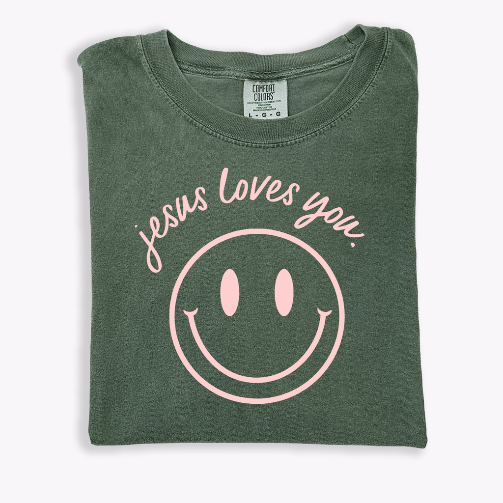 Jesus Loves You smiley graphic tee in relaxed fit cotton on a neutral background