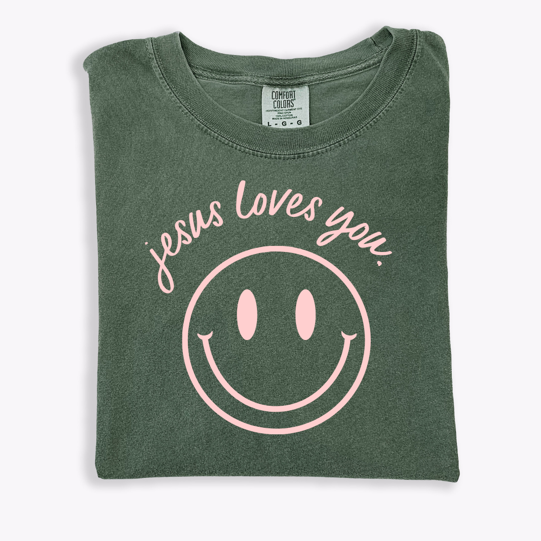 Jesus Loves You smiley graphic tee in relaxed fit cotton on a neutral background