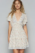 Women wearing a floral print v-neck mini dress with cutout back and flutter sleeves