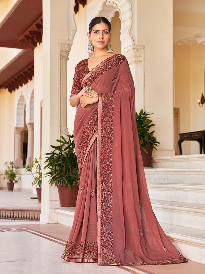 Rust colored designer georgette saree with artistic print for festive occasions