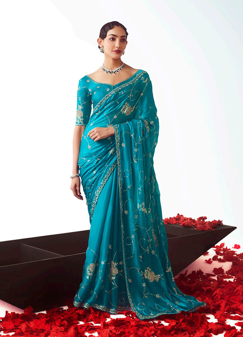 Turquoise blue ceremonial saree featuring detailed cut-work embroidery