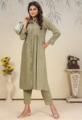 Woman wearing a Pista Green solid cotton co-ord set for casual or festival occasions