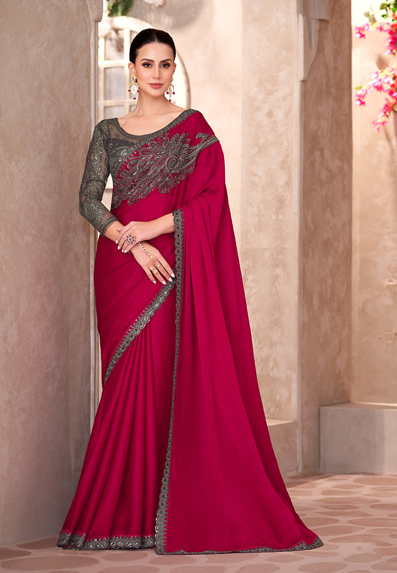 Close-up of raspberry chiffon silk saree featuring detailed embroidery and lace border work