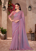 Elegant mauve pink georgette saree featuring a delicate golden embroidered lace border