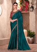 Teal green chiffon silk saree featuring ethnic embroidery and intricate lace borders
