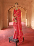 Red silk saree with classic patola print for festivals
