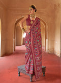 Maroon silk saree with intricate patola print for festival wear