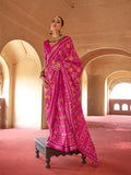 Vibrant Rani Pink silk saree with intricate traditional Patola designs