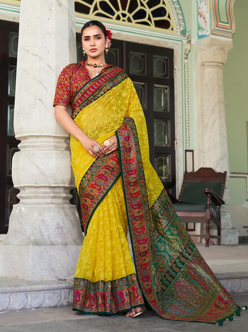 A vibrant yellow Lucknowi viscose georgette saree featuring delicate foil print details.