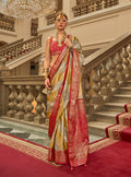 Model wearing a vibrant multi-color satin saree with traditional weaving print and elegant drape