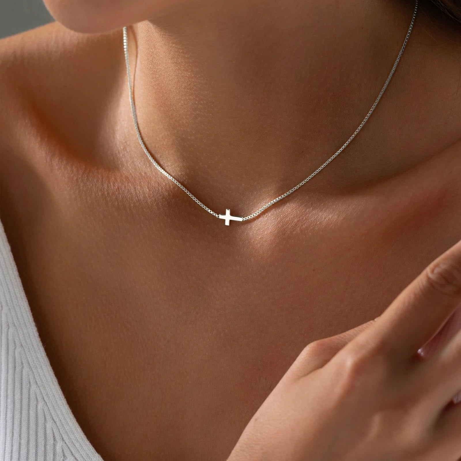 Minimalist geometric cross pendant necklace with a polished gold finish.