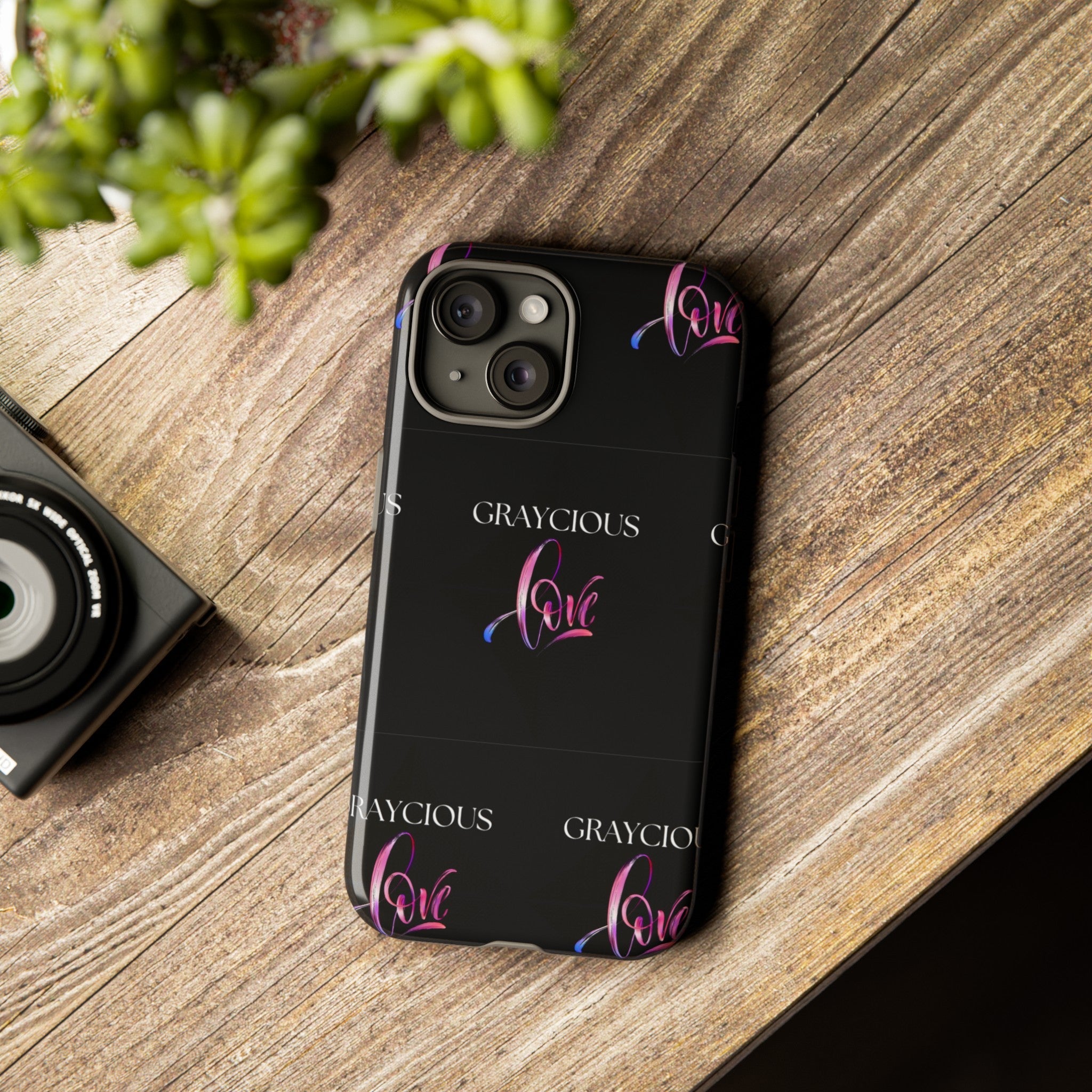 Dual layer tough phone case with black base and pink to blue gradient typography