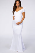 Pregnant woman wearing a white off-shoulder wrap maternity photoshoot gown